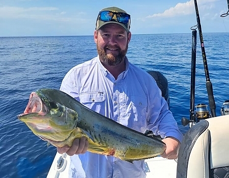 Man holding a large fish on a boat in Key Largo with Beyond Blessed Charters.