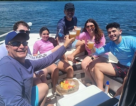 Group of people raising drinks on a boat during an Islamorada boat tour.