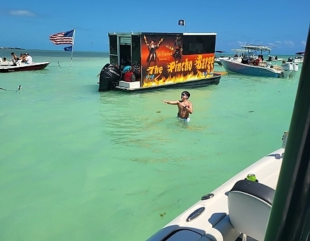 Floating bar in shallow water with boats around in the Florida Keys.