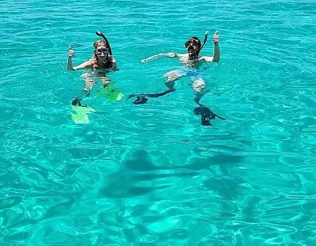 Two people snorkeling in clear blue water in the Florida Keys.