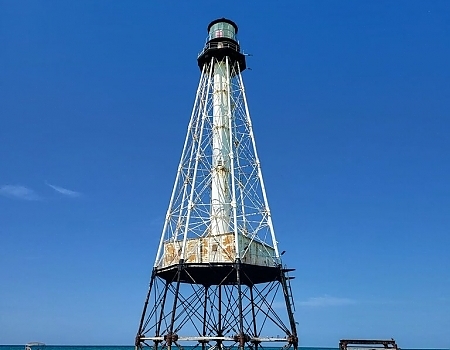 Tall lighthouse against a blue sky in the Florida Keys.